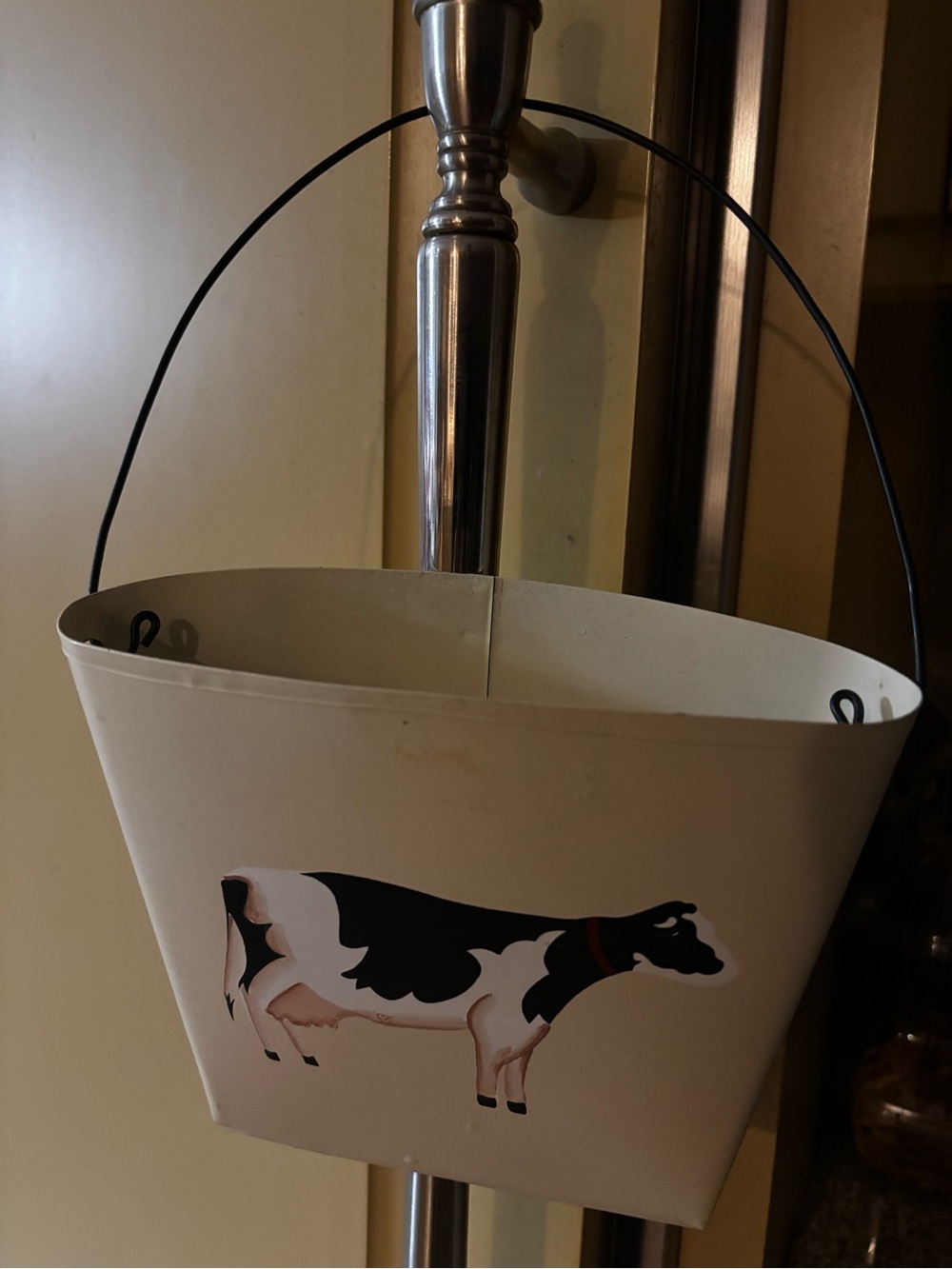 vintage metal bucket or planter featuring a hand-painted Holstein cow
